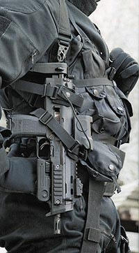 Германский спецназовец из группы GSG-9 с пистолетом-пулеметом МР7А1, пристегнутым к системе ношения с возможностью быстрого извлечения оружия