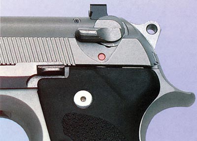 Флажковый предохранитель пистолета «Беретта» 96, смонтированный на кожухе-затворе, блокирует ударник и одновременно служит рычагом безопасного спуска курка