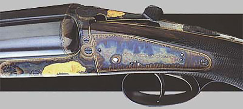 Двуствольный штуцер-нитроэкспресс «модель Dominion» (№ 31059) калибра .375 с обратными замками на досках. Сюжетная инкрустация золотом на африканскую тему. Ружьё сделано в 1935 году.